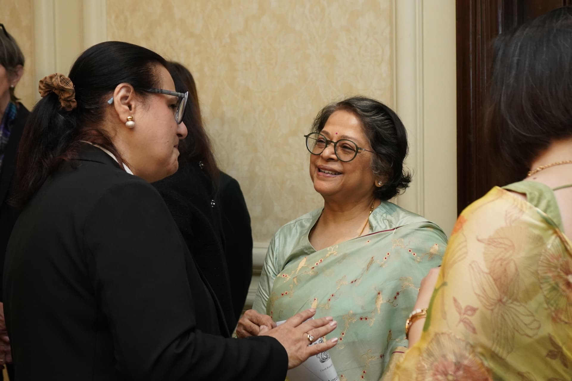 Delegates in conversation before the roundtable begins